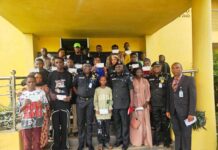 CP. Olufemi Abaniwonda in a Group Photograph with Recipients as Some Display their Cheques