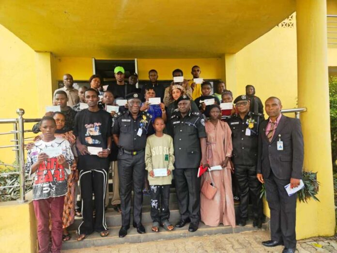 CP. Olufemi Abaniwonda in a Group Photograph with Recipients as Some Display their Cheques