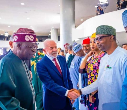President Luiz Inacio Lula da Silva in a warm handshake with Dr. Iziaq Adekunle Salako Honourable Minister of State for Health & Social Welfare.