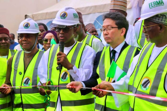 Hon Bello Goronyo Esq with FERMA Director The Honourable Minister of State for Works, Hon. Bello Muhammad Goronyo., Esq.(Middle ) flanked by the Managing Director Of FERMA, the Japanese Ambassador, Senate Committee chairman on FERMA, and other stakeholders while cutting the Ribbon during the Commissioning of the Japanese Donated Road Maintenance Equipment In Abuja. 1st August, 2025.