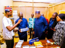 L - R, the team lead of D’More Food and Spices Brand, Tobi Olanrewaju and Minister of Agriculture and Food Security, Sen Abubakar Kyari during the inspection of the facility.
