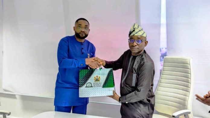 Director-General, Bureau of Public Procurement (BPP), Dr. Adebowale A. Adedokun, FCIPS, ACFE, right, exchanging pleasantries and souvenir with the CEO Equipment Leasing Registration Authority, Donald Wokoma, left, after a presentation on the Implementation of Ministry of Finance Circular on Leasing in Public Procurement