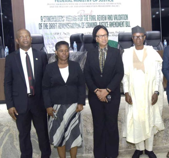 L/R, Representative of the Chief judge of Federal High Court, Justice Obiora Egwuatu, Director Solicitor, Mrs. Gladys Odegbaro, Director Administration of Criminal Justice and Reform Department, FMOJ. Mrs. Leticial Ayoola - Daniels and President Centre for Socio - Legal Studies and team Prof. Yemi Akinseye - George , dignitaries and participate in a Photograph during A Stakeholder' Meeting for the Final Review and Validation of the Draft Administration of Criminal Justice Amendment Bill at Olusegun Obasanjo Auditorium, Federal Ministry of justice, Maltama Abuja.