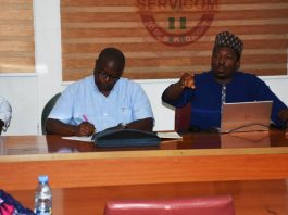 World Bank Project Coordinator, Mr Siakpere and his team briefing a Cross section of SERVICOM Management team