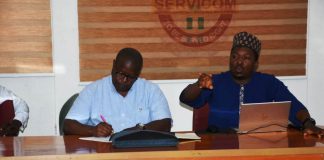 World Bank Project Coordinator, Mr Siakpere and his team briefing a Cross section of SERVICOM Management team