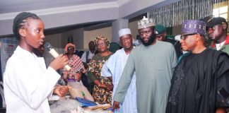 Rep. of the PS, FMIST, Deputy Director, Science Technology and Promotion (STP), Dr. Victor Fadipe (3rd right) Chief Host/Provost, FCT College of Education, Zuba, Dr. Sule Mundi (right) Chairman, House Committee on College of Education, Hon. Adamu Tanko (2nd right) and others with Student of Government Science and Technical College Area 3, Garki, Abuja, at the exhibition stand that Flexible Sanitary Pad from banana trunk waste at the event.