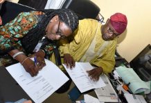 L-R : Deputy Director of Hydropower, Research and Development Energy Commission of Nigeria (NACHRED) Dr. Toyin Olugbemi and The Director of Geodesy at OSGOF, Surv. Duniya Magaji during the signing of Hydropower Development Natiowide MOU today