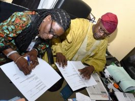 L-R : Deputy Director of Hydropower, Research and Development Energy Commission of Nigeria (NACHRED) Dr. Toyin Olugbemi and The Director of Geodesy at OSGOF, Surv. Duniya Magaji during the signing of Hydropower Development Natiowide MOU today