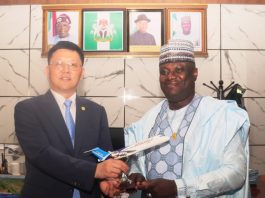 L-R: Deputy General Manager Comac Marketing and Sales Center, Yang Yang presenting a Souvenir to the Permanent Secretary Federal Ministry of Aviation and Aerospace Development; Dr. Ibrahim Abubakar Kana, mni during a courtesy call by COMAC