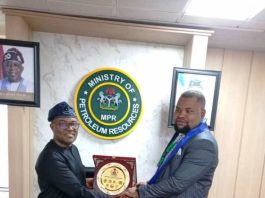 The representative of the Hon. Minister of State Petroleum Resources (Gas), Engr. Abel NSA (l), receiving a plaque from the Chairman of the Society for Human Development and Integration in Nigeria (SOHDIN) Mr. Lordswill Umani (r) during their courtesy visit to the Minister in Abuja.