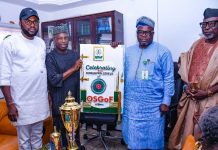 L-R : 2nd from left is Surv Yakubu Najimu Atanda , Chairman NIS (Abuja branch ) presenting their gift to Surveyor General of the Federation Surv. Abuduganiyu Adeyemi Adebomehin during the courtesy visit today