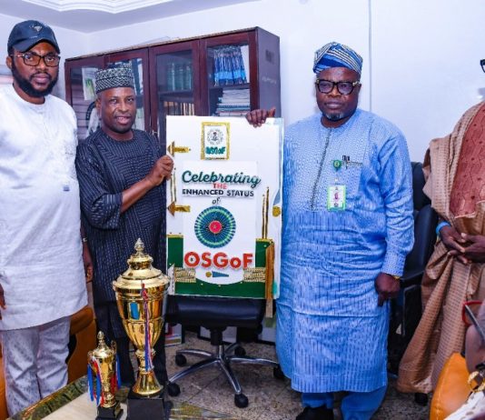 L-R : 2nd from left is Surv Yakubu Najimu Atanda , Chairman NIS (Abuja branch ) presenting their gift to Surveyor General of the Federation Surv. Abuduganiyu Adeyemi Adebomehin during the courtesy visit today