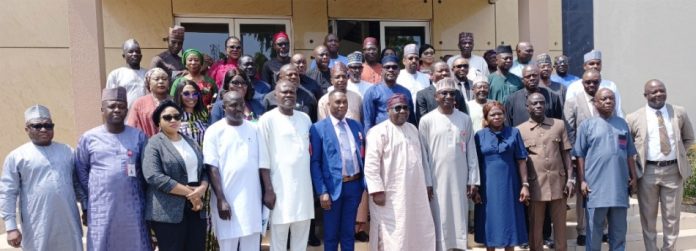 Representative of the Director-General, Bureau of Public Procurement (BPP) and Director, Civil Infrastructure Department (CID), BPP, Engr. Nasir M. Bello 5th right, Director-General, Bureau of Public Service Reforms (BPRS), Dr. Dasuki Ibrahim Arabi 7th left, Engr. Isaiah Yesufu 6th left, Director, Compliance, Certification and Monitoring Department (CCM), some management staff of the Bureau and Participants in a group photograph during Bureau's Three-Day Refresher Training/Workshop for Procurement Officers of SGL 14-16 in the Pool of the BPP in Abuja