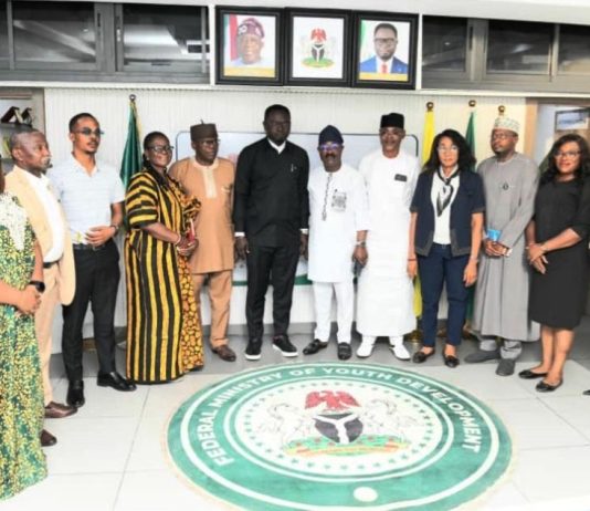 The Honourable Minister of Youth Development, Comrade Ayodele Olawande (middle), flanked by Management Staff of the Ministry, CEO of House of Destiny Global Limited and the National Commercial Tricycle and Motorcycle Owners and Riders Association of Nigeria (NATOMORAS), during the signing of a tripartite agreement aimed at empowering Nigerian youth, held in Abuja.