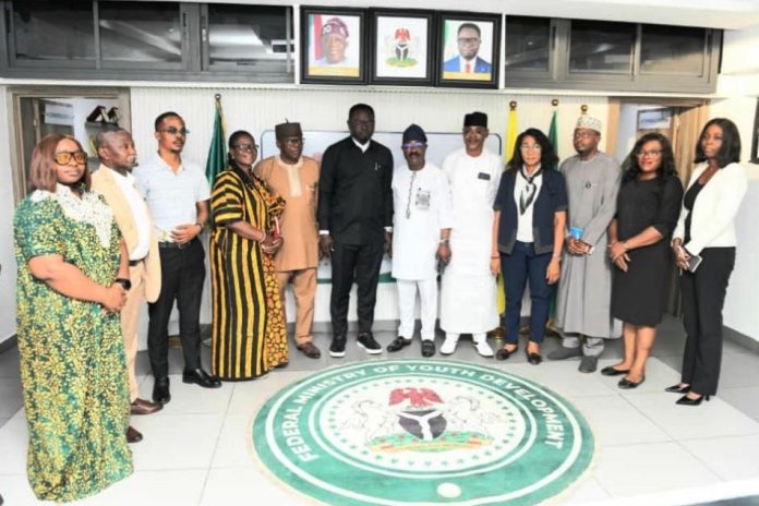 Honourable Minister flanked by Management Staff of the Ministry The Honourable Minister of Youth Development, Comrade Ayodele Olawande (middle), flanked by Management Staff of the Ministry, CEO of House of Destiny Global Limited and the National Commercial Tricycle and Motorcycle Owners and Riders Association of Nigeria (NATOMORAS), during the signing of a tripartite agreement aimed at empowering Nigerian youth, held in Abuja.