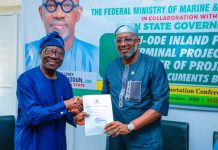 The Permanent Secretary, Federal Ministry of Marine and BlueEconomy, Olufemi Oloruntola, (l) receiving the title document for 130 hectares of land for construction of Inland Dry Port in Ijebu Ode from the Ogun State Commissioner of Transportation, Engr. Gbenga Dairo.