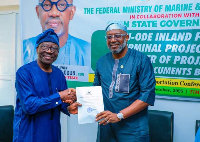 The Permanent Secretary, Federal Ministry of Marine and BlueEconomy, Olufemi Oloruntola, (l) receiving the title document for 130 hectares of land for construction of Inland Dry Port in Ijebu Ode from the Ogun State Commissioner of Transportation, Engr. Gbenga Dairo.