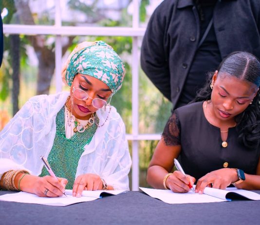 The Minister of Art, Culture, Tourism and Creative Economy, Hannatu Musa Musawa, and Julia Azubuike, Program Director of Lens for Good Initiative, sign Strategic MoU with Lens for Good Initiative to empower Nigerian creatives through innovation, storytelling, and skill development. October 20th, 2025, Abuja, Nigeria.