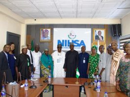 The Executive Director, NIWRMC, Dr Abdulmumini Aminu Zaria (7th L) and the Director General of NIHSA, Umar Ibrahim Muhammed (7th R) with staff of both Agencies in Abuja