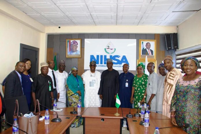 NIWRMC forge alliance with NIHSA The Executive Director, NIWRMC, Dr Abdulmumini Aminu Zaria (7th L) and the Director General of NIHSA, Umar Ibrahim Muhammed (7th R) with staff of both Agencies in Abuja