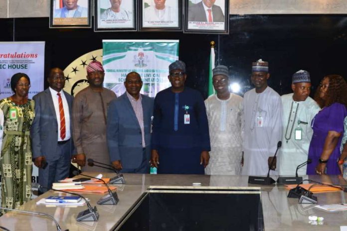 Permanent Secretary, Dr Shuaib Belgore in a group picture with Inaugurated Members of the Departmental Award Selection Committee of the Federal Ministry of Housing and Urban Development.