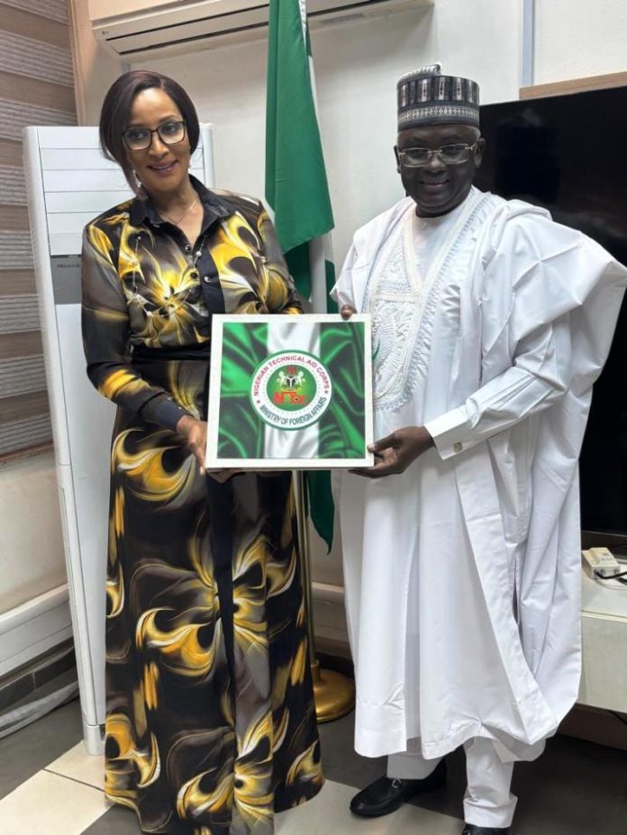 working visit by the DG The Minister of State for Foreign Affairs, Amb. Bianca Odumegwu-Ojukwu (Left) and the Director-General, Nigerian Technical Aid Corps, Rt. Hon. Yusuf Buba Yakub, pose for a photo session after a working visit by the DG to the Ministry Headquarters in Abuja on *Friday, October 10, 2025. The NTAC DG here presenting to the Hon. Minister, paraphernalia of his stewardship at the Nigerian Technical Aid Corps in the last two years.