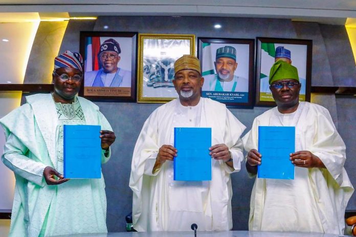 L-R, the Director General, NASRDA, Dr Mathew Adepoju, Minister of Agriculture and Food Security, Sen Abubakar Kyari and Permanent Secretary, Dr Marcus Ogunbiyi during the Signing of Memorandum of Understanding.