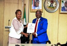 The new Permanent Secretary MPR. Mrs. Oyekunle Patience Nwakuso (left) receiving the handover documents from the outgoing Permanent Secretary Dr. Emeka Vitalis Obi mni (right) in Abuja.
