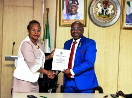 The new Permanent Secretary MPR. Mrs. Oyekunle Patience Nwakuso (left) receiving the handover documents from the outgoing Permanent Secretary Dr. Emeka Vitalis Obi mni (right) in Abuja.