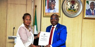 The new Permanent Secretary MPR. Mrs. Oyekunle Patience Nwakuso (left) receiving the handover documents from the outgoing Permanent Secretary Dr. Emeka Vitalis Obi mni (right) in Abuja.