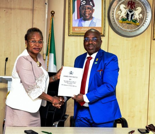 The new Permanent Secretary MPR. Mrs. Oyekunle Patience Nwakuso (left) receiving the handover documents from the outgoing Permanent Secretary Dr. Emeka Vitalis Obi mni (right) in Abuja.