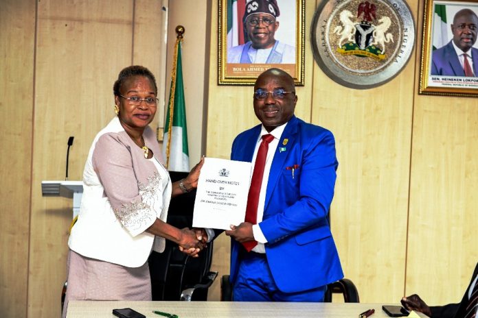Mrs. Oyekunle Patience Nwakuso and Dr. Emeka Vitalis Obi The new Permanent Secretary MPR. Mrs. Oyekunle Patience Nwakuso (left) receiving the handover documents from the outgoing Permanent Secretary Dr. Emeka Vitalis Obi mni (right) in Abuja.