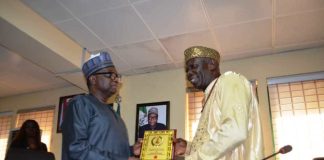 RMAFC Chairman, Dr. Mohammed Bello Shehu OFR presenting a memorabilia to Chairman HOSCON, Prince Michael Emuh
