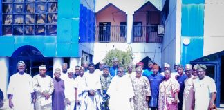 In the middle roll with dark glasses in white brocade is the Surveyor General of the Federation with some of the participants at the meeting