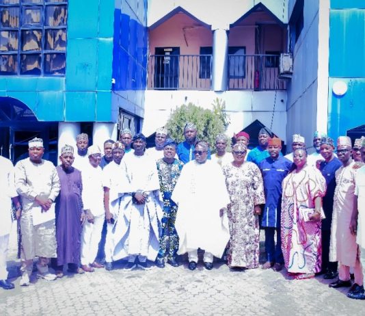 In the middle roll with dark glasses in white brocade is the Surveyor General of the Federation with some of the participants at the meeting