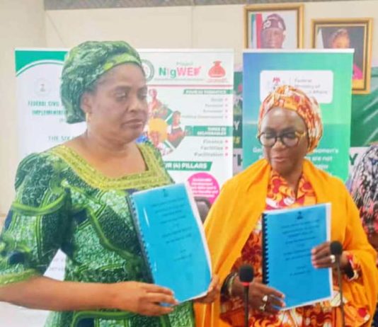 R-L : The Out Permanent Secretary, Dr. Maryam Ismaila Keshinro, formally handing over to the incoming Permanent Secretary, Mrs. Esuabana Nko Asanye, during the event held in FMWASD Headquarters, Abuja