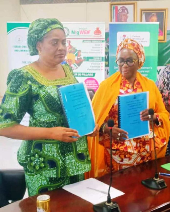 R-L : The Out Permanent Secretary, Dr. Maryam Ismaila Keshinro, formally handing over to the incoming Permanent Secretary, Mrs. Esuabana Nko Asanye, during the event held in FMWASD Headquarters, Abuja