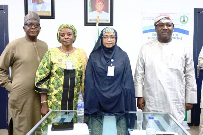 The Permanent Secretary, Federal Ministry of Marine and Blue Economy, Fatima Mahmood (3rd l) flanked by Director, Maritime Services, Oyinloye Meshack (1st l), Director, Planning, Research and Statistics, Kalthum Ibrahim (2nd l) and Director, Maritime Safety and Security, Babatunde Bombata (1st r) after briefing the Permanent Secretary.