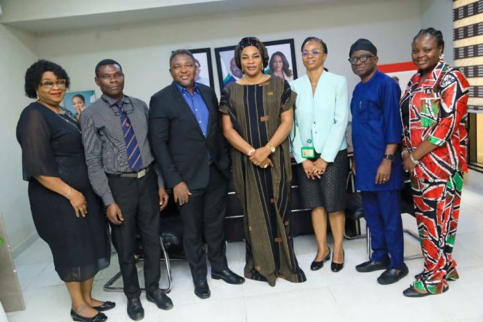 The Commissioner for Women Affairs and Social Development, Mrs. Eugenia Abdallah (center), alongside the Permanent Secretary, Mrs. Joy Ihensekhien (third right), and the Chief Medical Director of NOFIC, Prof. Ileogben Sunday-Adeoye (third left), pose with members of the Centre’s management during their engagement in Benin City.