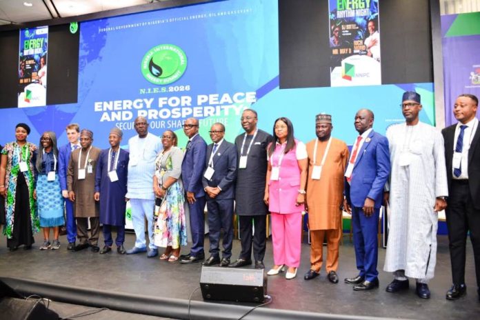 (6th left) The Honourable Minister of State Petroleum Resources (Oil) Sen. Heineken Lokpobiri and (5th right) the Permanent Secretary MPR. Mrs. Patience N. Oyekunle flanked by other dignitaries in the Oil and Gas Industry in a group photograph during the closing ceremony of NIES 2026 that took place in Abuja.