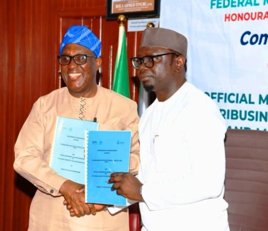 R–L: The Honourable Minister, Federal Ministry of Youth Development, Comrade Ayodele Olawande, and the Director-General, International Institute of Tropical Agriculture (IITA), Dr. Simeon Ehui, displaying the Memorandum of Understanding (MoU) document following its signing during the launch of the Youth in Agribusiness Land Trust Fund (YALTF), today at the Minister’s Office, Abuja.