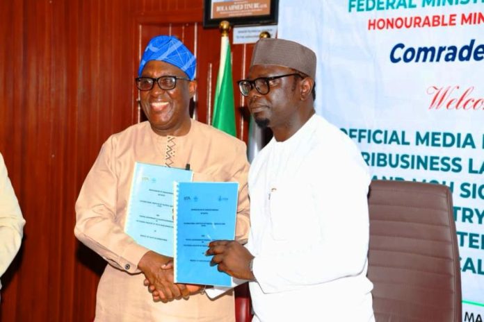 R–L: The Honourable Minister, Federal Ministry of Youth Development, Comrade Ayodele Olawande, and the Director-General, International Institute of Tropical Agriculture (IITA), Dr. Simeon Ehui, displaying the Memorandum of Understanding (MoU) document following its signing during the launch of the Youth in Agribusiness Land Trust Fund (YALTF), today at the Minister’s Office, Abuja.