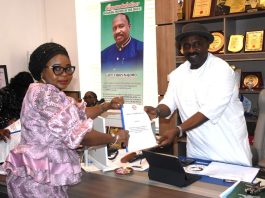 Acting National Coordinator SERVICOM Presidency,Mrs Helen Lawal, presenting the evaluation report of the Nigerian Civil Aviation Authority ( NCAA) to the Director General, Captain Chris Najomo in his office.