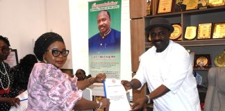 Acting National Coordinator SERVICOM Presidency,Mrs Helen Lawal, presenting the evaluation report of the Nigerian Civil Aviation Authority ( NCAA) to the Director General, Captain Chris Najomo in his office.