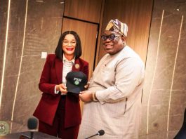 The Honorable Chairman Federal Civil Service Commission Prof Tunji Olaopa receiving a customized face cap from the Administrative CEO Public Service Institute of Nigeria Imeh Okon Esq.