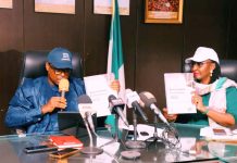 Honorable Minister of State for Health and Social Welfare Dr Iziaq Adekunle Salako and Permanent Secretary Federal Ministry of Health and Social Welfare,Daju Kachollom S. mni displaying the National Health Facility Survey Document launched at Ministerial Press briefing marking 2026 World Health Day.