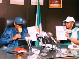 Honorable Minister of State for Health and Social Welfare Dr Iziaq Adekunle Salako and Permanent Secretary Federal Ministry of Health and Social Welfare,Daju Kachollom S. mni displaying the National Health Facility Survey Document launched at Ministerial Press briefing marking 2026 World Health Day.