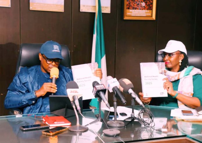 Honorable Minister of State for Health and Social Welfare Dr Iziaq Adekunle Salako and Permanent Secretary Federal Ministry of Health and Social Welfare,Daju Kachollom S. mni displaying the National Health Facility Survey Document launched at Ministerial Press briefing marking 2026 World Health Day.