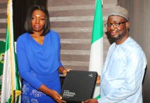 The leader of the delegation Ms Seun Ojo presents a proposed working document to the Honourable Minister. Dr. Bernard M Doro during the visit.