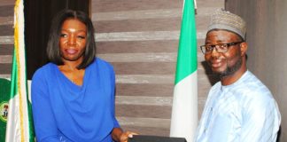 The leader of the delegation Ms Seun Ojo presents a proposed working document to the Honourable Minister. Dr. Bernard M Doro during the visit.